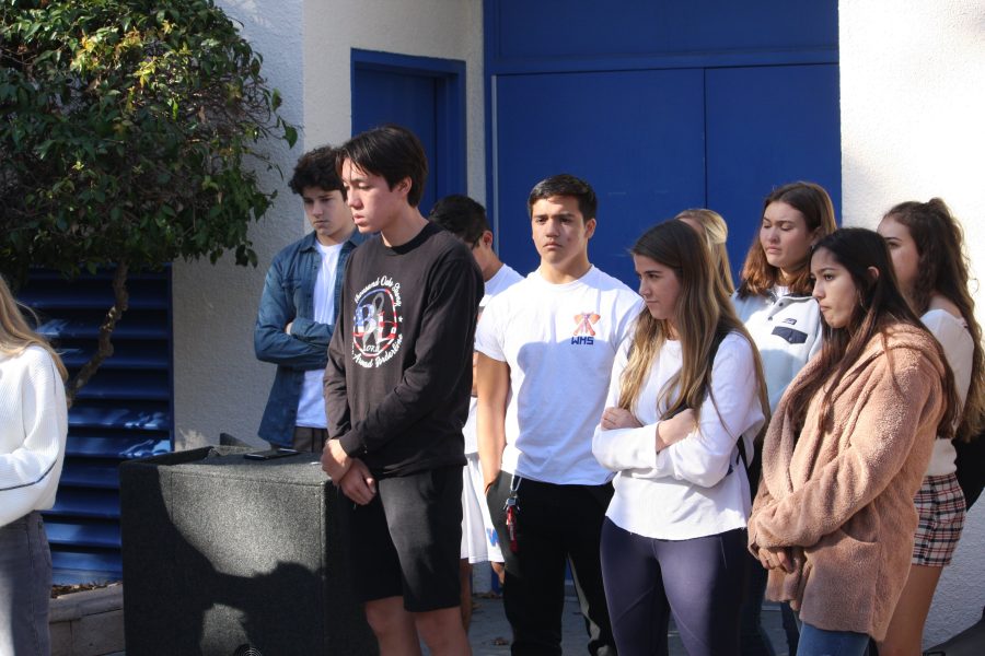 Members of ASG stand behind the organizers of the vigil, looking on and supporting the planners.