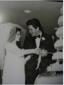 THE ICONIC DAY: Priscilla and Elvis Presley cutting their cake at their 1967 wedding reception.