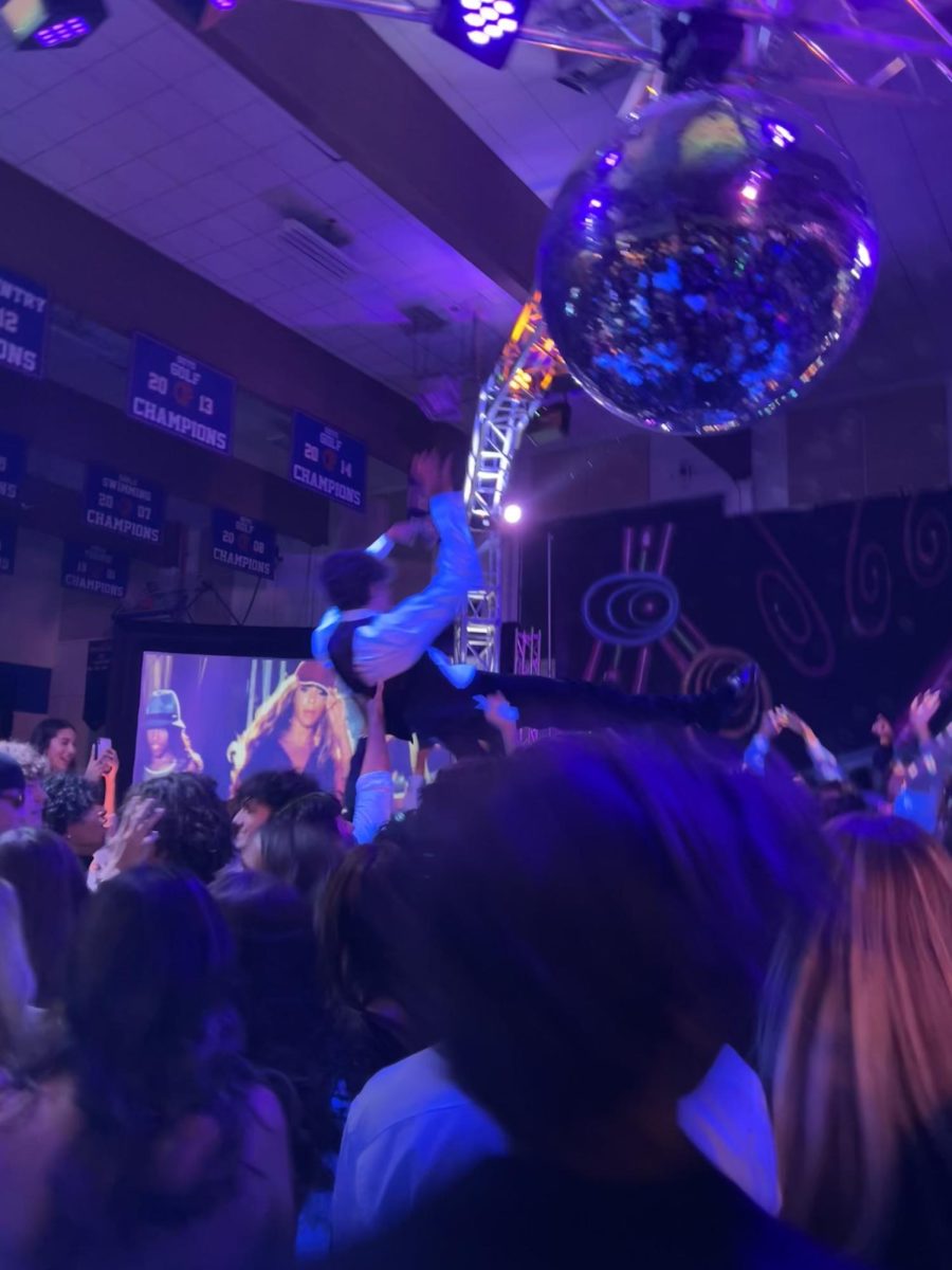 FLASHING LIGHTS: WHS students party at homecoming in 2023, a “quintessential" high school event according to pop culture. Dances and school events like this come alongside unique social environments and emotions, which can be difficult to manage.