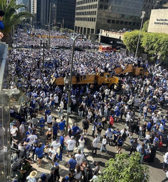 Jubilation: Dodgers fans line the streets near the Los Angeles Central Library at the end of the parade route. The procession started at Los Angeles City Hall and lasted around 45 minutes. The parade was followed by a ceremony at Dodgers Stadium, which was sold out with a crowd of over 50,000 in attendance.