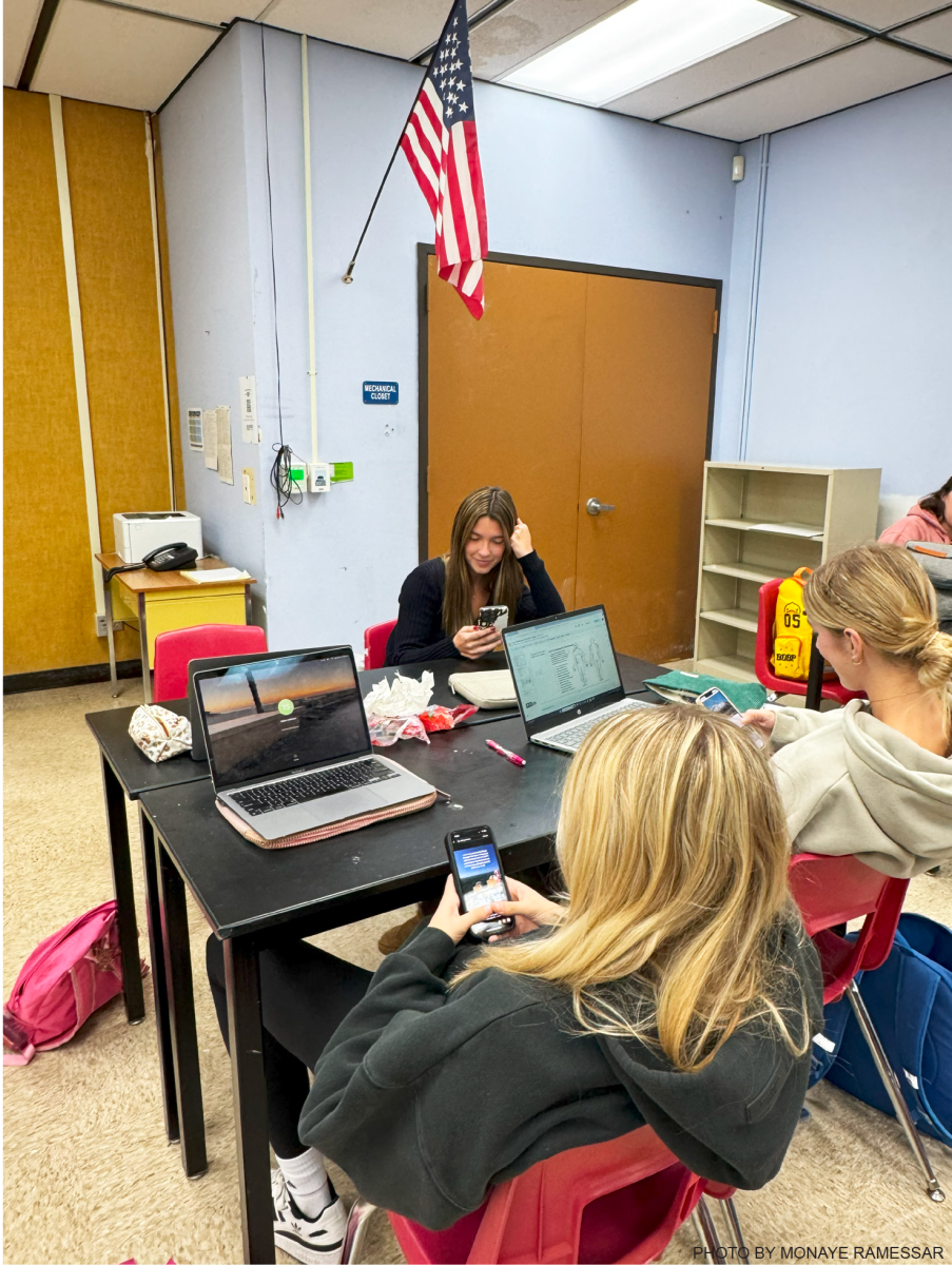 LOOKING IT UP: Taylor Swanson ‘25, Lauren Sommers ‘25 and Sophia Rabe ‘25 are all utilizing their devices to complete their assignments. 