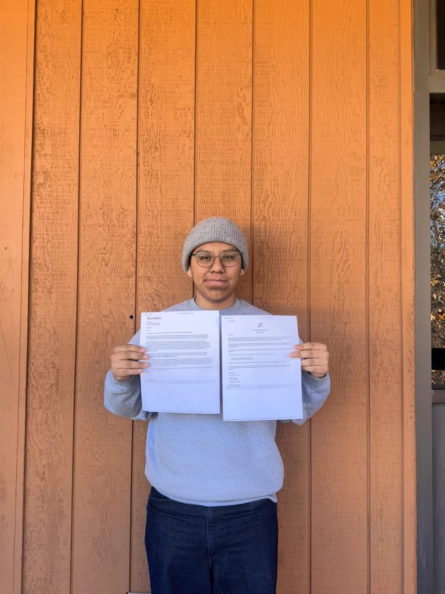 AMAZING ACHIEVEMENT: Oscar Ruiz '26 holds his acceptance letters to the highly selective Bowdoin College, marking one of the first steps into his future.